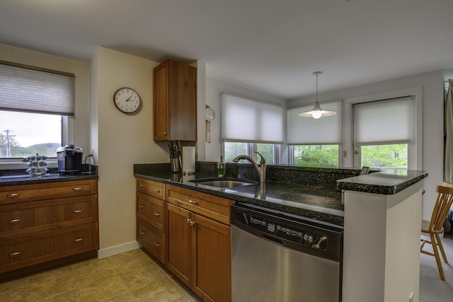 782 E Mountain Rd Unit C2, Killington, VT 05751 - kitchen with stainless steel dishwasher, a sink, brown cabinetry, dark stone counters, and hanging light fixtures