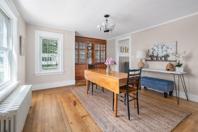 354 Dover Point Rd, Dover, NH 03820 - home office with radiator heating unit, a chandelier, baseboards, wood finished floors, and crown molding