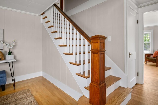 354 Dover Point Rd, Dover, NH 03820 - stairway with wood finished floors, crown molding, baseboards, and a decorative wall