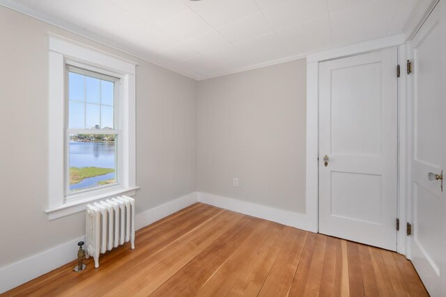 354 Dover Point Rd, Dover, NH 03820 - spare room featuring radiator, light wood-style floors, a water view, and baseboards