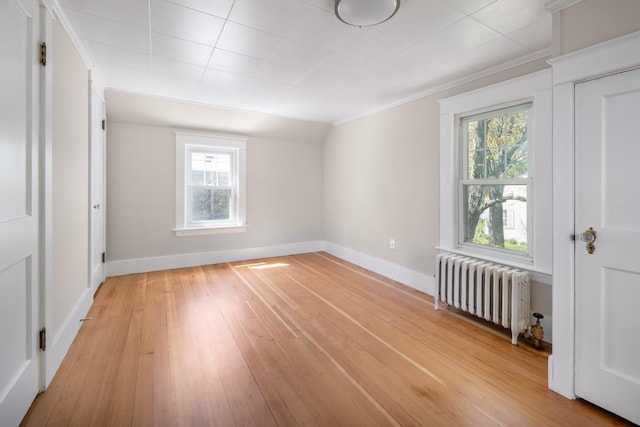 354 Dover Point Rd, Dover, NH 03820 - unfurnished bedroom with radiator, multiple windows, light wood finished floors, baseboards, and crown molding