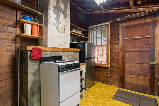 17 Hayes Ln, Acton, ME 04001 - kitchen with white range with electric stovetop, wooden walls, freestanding refrigerator, tile patterned floors, and open shelves