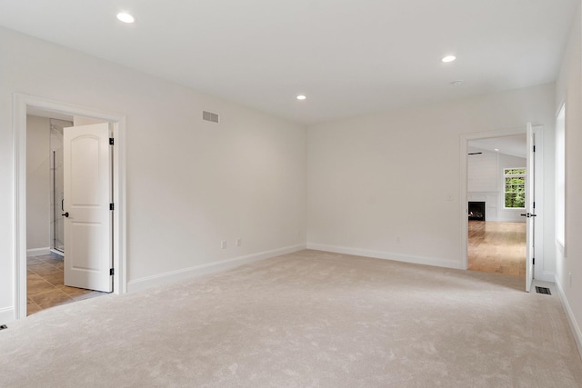 380 Greenfield Rd, Peterborough, NH 03458 - empty room with light colored carpet, recessed lighting, a large fireplace, and baseboards