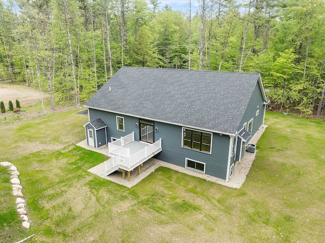 380 Greenfield Rd, Peterborough, NH 03458 - back of property with roof with shingles, a wooden deck, central AC unit, a lawn, and a wooded view