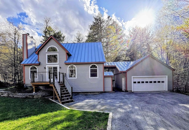 31 Plumley Ave, Ludlow, VT 05149 - view of front facade featuring metal roof, a wooden deck, a standing seam roof, a chimney, and stairway