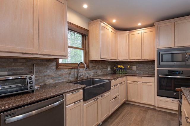 31 Plumley Ave, Ludlow, VT 05149 - kitchen with appliances with stainless steel finishes, a sink, light brown cabinets, dark stone countertops, and recessed lighting