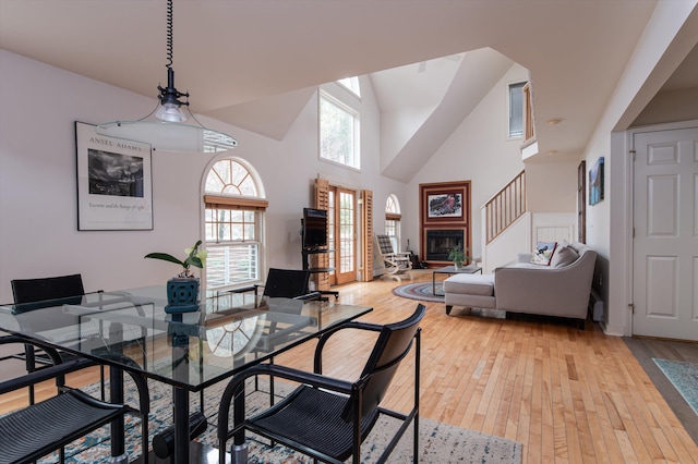 31 Plumley Ave, Ludlow, VT 05149 - dining area with light wood-type flooring, healthy amount of natural light, high vaulted ceiling, and stairway