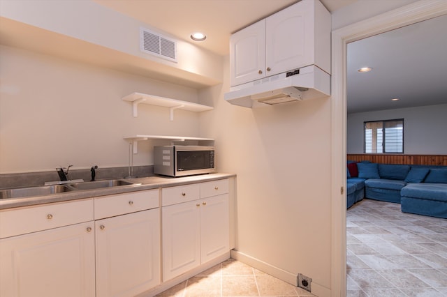 31 Plumley Ave, Ludlow, VT 05149 - kitchen featuring stainless steel microwave, a sink, under cabinet range hood, open shelves, and white cabinets