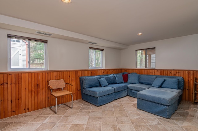 31 Plumley Ave, Ludlow, VT 05149 - living area with wainscoting, wooden walls, healthy amount of natural light, and recessed lighting
