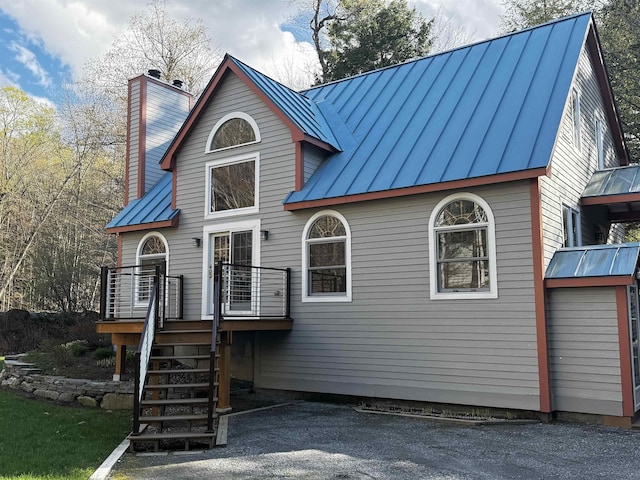 31 Plumley Ave, Ludlow, VT 05149 - rear view of house featuring a standing seam roof, metal roof, a chimney, and a deck