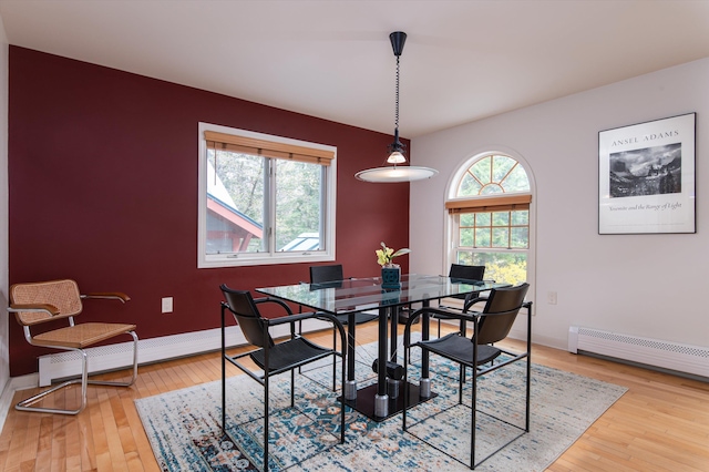 31 Plumley Ave, Ludlow, VT 05149 - dining area with a baseboard radiator, wood finished floors, and baseboards