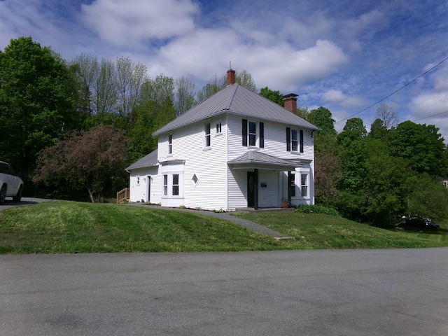 117 Middle St, Newport City, VT 05855 - view of front of home featuring a chimney, metal roof, a front yard, and a standing seam roof