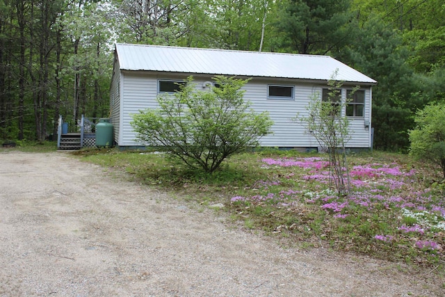 86 Concord Ln, Wakefield, NH 03830 - view of side of home with metal roof and a forest view