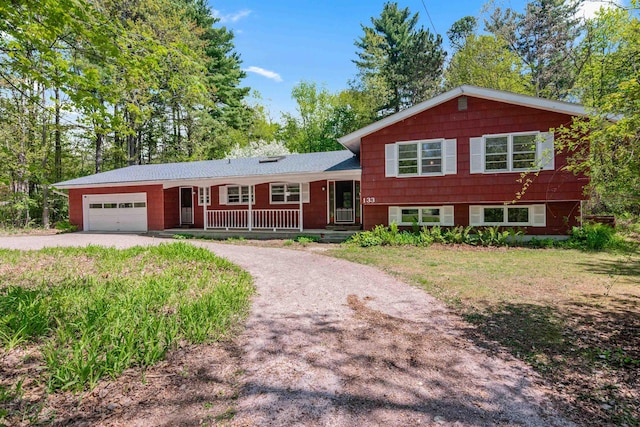 133 Pine Meadow Dr, Colchester, VT 05446 - split level home with driveway, a garage, and a porch