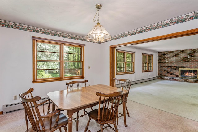 133 Pine Meadow Dr, Colchester, VT 05446 - dining space featuring light colored carpet, a chandelier, healthy amount of natural light, and a brick fireplace