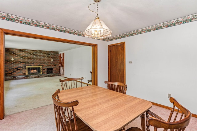 133 Pine Meadow Dr, Colchester, VT 05446 - dining space featuring carpet floors, a chandelier, a fireplace, and baseboards