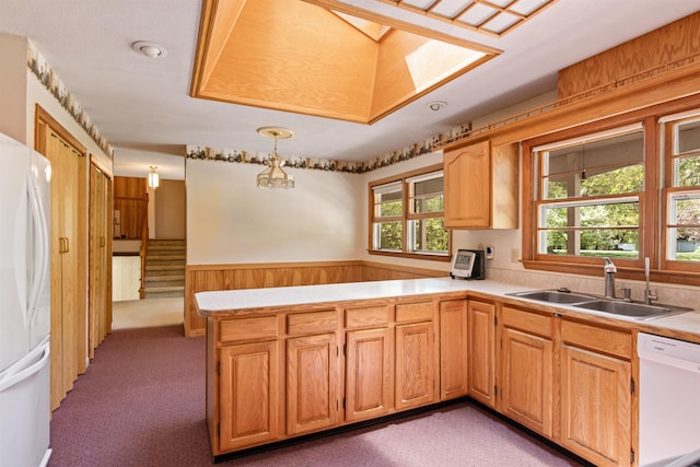133 Pine Meadow Dr, Colchester, VT 05446 - kitchen with a sink, white appliances, a peninsula, light countertops, and light colored carpet