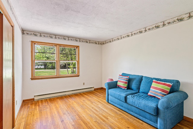 133 Pine Meadow Dr, Colchester, VT 05446 - sitting room featuring a baseboard heating unit, hardwood / wood-style flooring, a textured ceiling, and baseboards