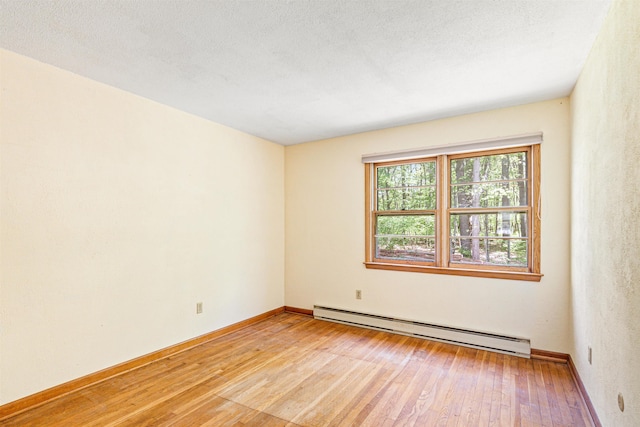 133 Pine Meadow Dr, Colchester, VT 05446 - empty room with a baseboard radiator, light wood finished floors, and baseboards