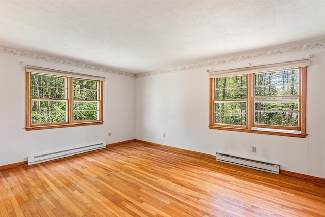 133 Pine Meadow Dr, Colchester, VT 05446 - unfurnished room with baseboard heating, plenty of natural light, and light wood-style floors
