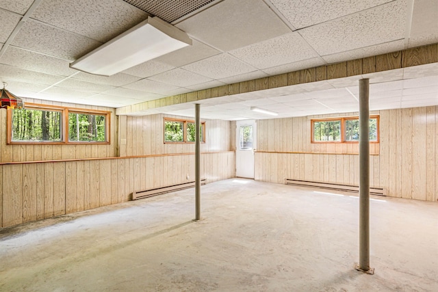 133 Pine Meadow Dr, Colchester, VT 05446 - below grade area with a baseboard heating unit, a paneled ceiling, and wood walls