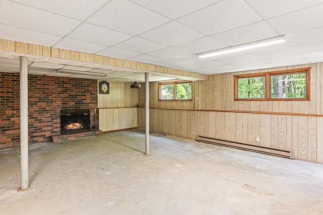 133 Pine Meadow Dr, Colchester, VT 05446 - basement featuring baseboard heating, a fireplace, a paneled ceiling, and wooden walls