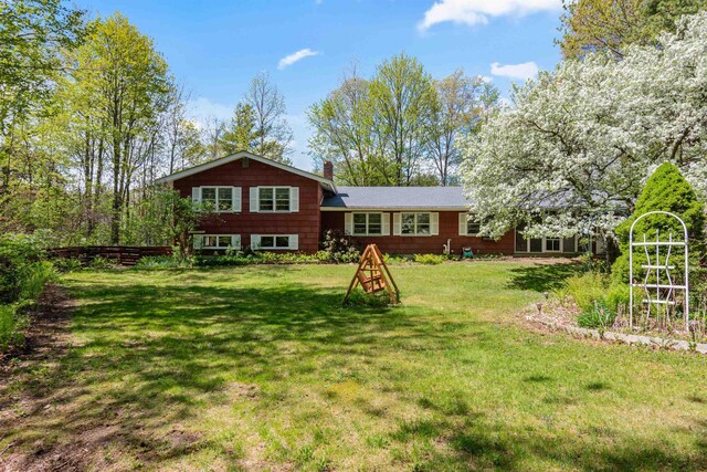 133 Pine Meadow Dr, Colchester, VT 05446 - rear view of house with a chimney