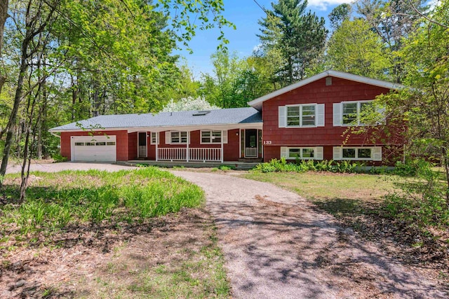 133 Pine Meadow Dr, Colchester, VT 05446 - tri-level home with covered porch, driveway, and an attached garage