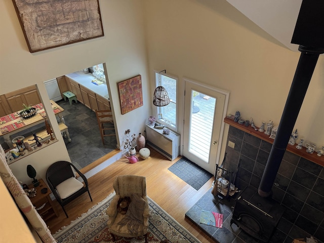220 Foggs Ridge Rd, Ossipee, NH 03864 - living area featuring a wood stove, wood finished floors, and a high ceiling