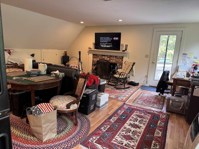 220 Foggs Ridge Rd, Ossipee, NH 03864 - living area featuring wood finished floors, vaulted ceiling, recessed lighting, and a brick fireplace