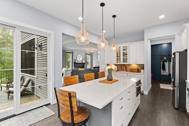 36 Caspian Ln, Shelburne, VT 05482 - kitchen with stainless steel appliances, white cabinetry, dark wood-style floors, healthy amount of natural light, and recessed lighting