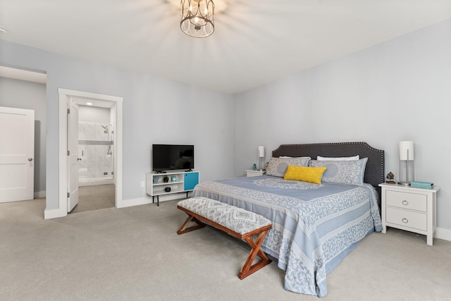 36 Caspian Ln, Shelburne, VT 05482 - carpeted bedroom with baseboards, connected bathroom, and a chandelier