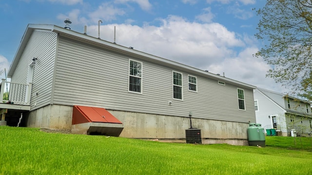 26 Deerfield Ct, Rochester, NH 03868 - back of house featuring a yard and central air condition unit