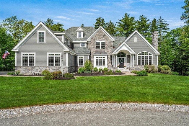 72 Settlers Ct, Bedford, NH 03110 - view of front of home featuring stone siding, a front lawn, and a chimney