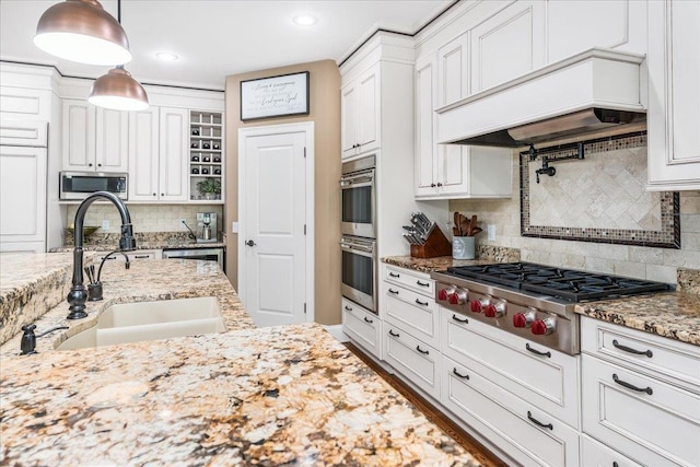 72 Settlers Ct, Bedford, NH 03110 - kitchen featuring a sink, custom exhaust hood, stainless steel appliances, backsplash, and white cabinetry