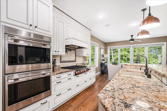 72 Settlers Ct, Bedford, NH 03110 - kitchen with a sink, appliances with stainless steel finishes, a ceiling fan, tasteful backsplash, and white cabinets
