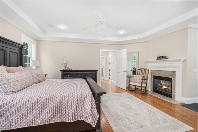 72 Settlers Ct, Bedford, NH 03110 - bedroom featuring a raised ceiling, a fireplace, wood finished floors, recessed lighting, and ceiling fan