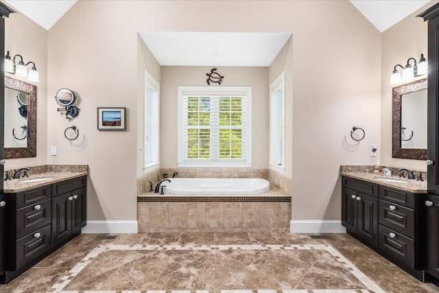 72 Settlers Ct, Bedford, NH 03110 - full bath with vaulted ceiling, baseboards, two vanities, and a bath