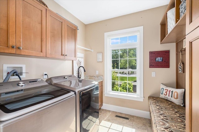 72 Settlers Ct, Bedford, NH 03110 - laundry room with cabinet space, separate washer and dryer, baseboards, and light tile patterned floors