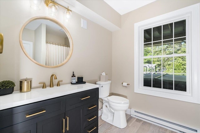 72 Settlers Ct, Bedford, NH 03110 - full bathroom featuring a baseboard heating unit, vanity, toilet, wood finished floors, and baseboards