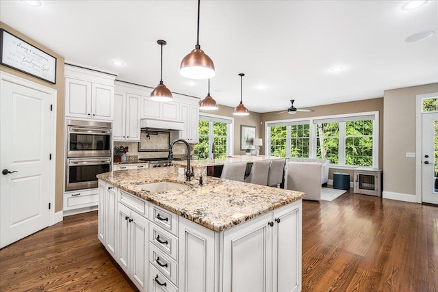72 Settlers Ct, Bedford, NH 03110 - kitchen featuring double oven, a sink, ceiling fan, white cabinets, and dark wood-style floors