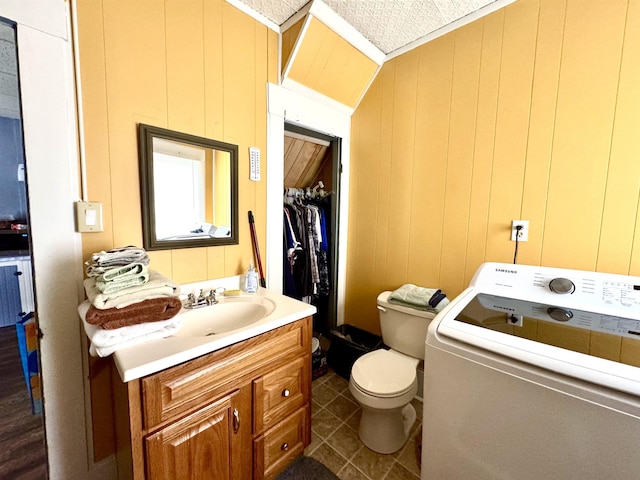 15 Park St, Colebrook, NH 03576 - bathroom with washer / clothes dryer, toilet, vanity, and tile patterned flooring