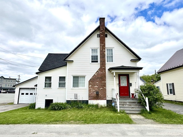 15 Park St, Colebrook, NH 03576 - traditional home with a chimney, asphalt driveway, a front lawn, a garage, and a shingled roof