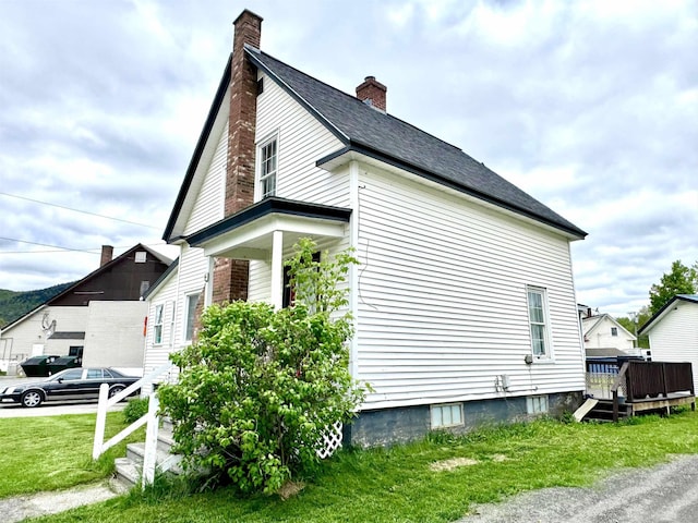 15 Park St, Colebrook, NH 03576 - view of home's exterior featuring a chimney and a lawn