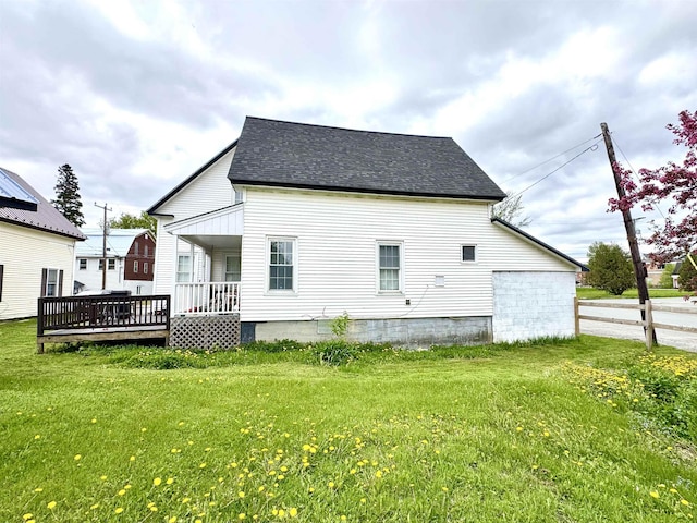 15 Park St, Colebrook, NH 03576 - back of property with a lawn, roof with shingles, and a deck