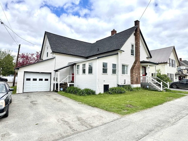 15 Park St, Colebrook, NH 03576 - view of home's exterior with an attached garage, a chimney, a lawn, driveway, and roof with shingles