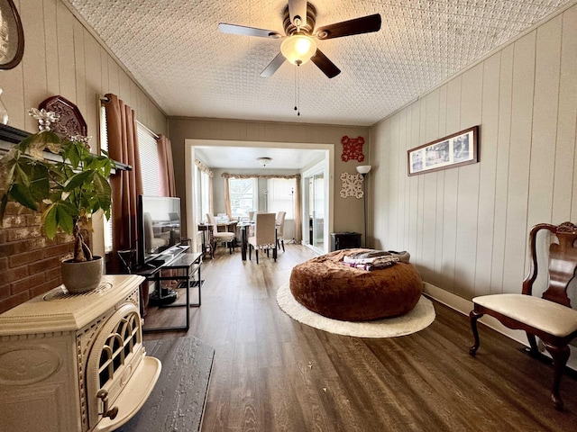 15 Park St, Colebrook, NH 03576 - living area with wood finished floors, ceiling fan, and wooden walls
