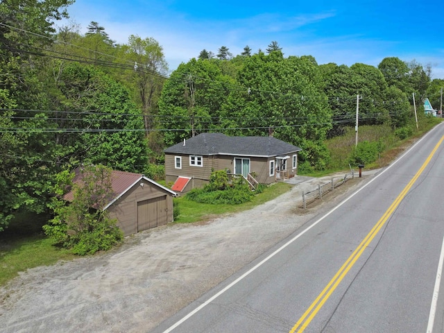 20 Daniel Webster Hwy, Plymouth, NH 03264 - view of front of property featuring a wooded view, an outbuilding, driveway, and a detached garage