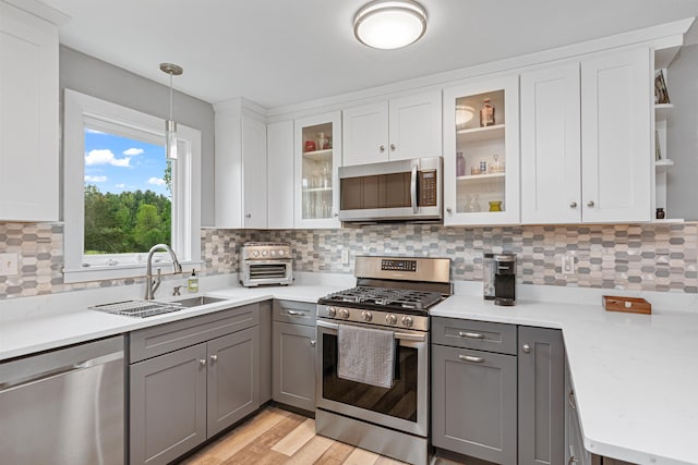 870 Cheesefactory Rd, Shelburne, VT 05482 - kitchen with stainless steel appliances, a sink, gray cabinetry, open shelves, and light countertops