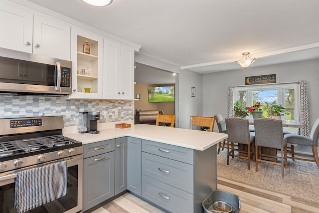 870 Cheesefactory Rd, Shelburne, VT 05482 - kitchen with appliances with stainless steel finishes, a peninsula, white cabinets, and plenty of natural light
